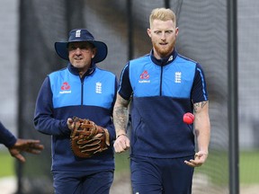 England coach Trevor Bayliss (left) and Ben Stokes experiment with a pink ball during a night training session on Aug. 14, 2017. (AARON CHOWN/AP)