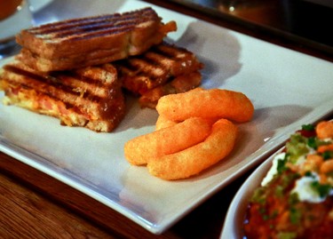 A grilled cheese made with Cheetos is shown during a press preview for a three-day pop-up restaurant featuring an all-Cheetos menu, Tuesday Aug. 15, 2017, in New York. Celebrity chef Anne Burrell has been given the unenviable task of creating an entire menu for a pop-up restaurant based on Cheetos. (AP Photo/Bebeto Matthews)