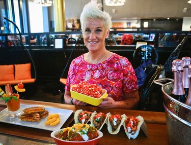 Food Network star Anne Burrell shows off some of her creations for an all-Cheetos menu for a three-day pop-up restaurant, during a press preview, Tuesday Aug. 15, 2017, in New York. Menu includes, Cheetos meatballs, Cheetos crusted fried pickles, Cheetos tacos, Mac n' Cheetos and Cheetos cheesecake. (AP Photo/Bebeto Matthews)