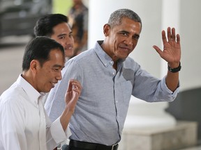 In this June 30, 2017, file photo, former U.S. President Barack Obama waves to reporters as he walks with Indonesian President Joko Widodo, left, upon arrival for their meeting at the Bogor Presidential Palace in Bogor, West Java, Indonesia. Obama's Aug. 12, 2017, tweet in response to the violence in Charlottesville, Virginia, is already one of the platform’s most-liked posts.(AP Photo/Dita Alangkara, Pool, File)