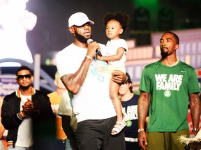 Cleveland Cavaliers' LeBron James speaks while holding his daughter, Zhuri, during the We Are Family Reunion at Cedar Point in Sandusky, Ohio, Tuesday, Aug. 15, 2017. (Erin McLaughlin/The Sandusky Register via AP)