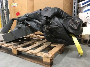 A damaged nearly century-old Confederate statue lies on a pallet in a warehouse in Durham, N.C. on Tuesday, Aug. 15, 2017. The Confederate Soldiers Monument, dedicated in 1924, stood in front of an old courthouse building that serves as local government offices. (Allen Breed/AP Photo)