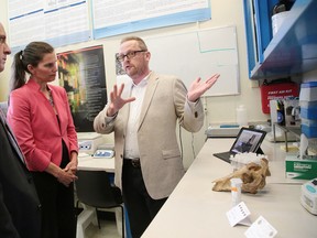 Kirsty Duncan, Canada's minister of Science. chats Tuesday with James Watterson, professor and chair in the Department of Forensic Science in his lab at Laurentian University, as Pierre Zundel, Interim President and Vice-Chancellor Designate, at Laurentian looks on in Sudbury. Duncan was in Sudbury for a funding announcement. Gino Donato/Sudbury Star/Postmedia Network
