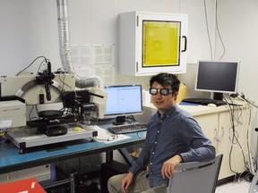 Herman Wong, a University of Toronto engineering and photonics Phd. student, tests eclipse glasses with an ellipsometer at the University of Toronto on Thursday, August 10, 2017. (THE CANADIAN PRESS/Lucas Timmons)