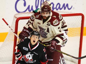 Peterborough Petes' defenceman Cam Lizotte checks Niagara IceDogs' Mikkel Aagaard during first period OHL action on Saturday October 3, 2015 at the Memorial Centre in Peterborough, Ont. Clifford Skarstedt/Peterborough Examiner/Postmedia Network