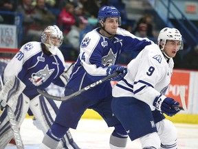 Sudbury Wolves forward Chandler Yakimowicz , and Mississauga Steelheads Michael McLeod battle for position during OHL action in Sudbury, Ont. on Sunday January 15, 2017. The Sudbury Wolves won in a shootout.Gino Donato/Sudbury Star/Postmedia Network