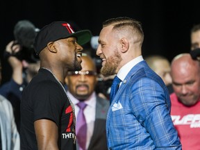 Boxing champ Floyd Mayweather and UFC lightweight champion Conor McGregor promote their upcoming boxing match during an appearance at Budweiser Stage in Toronto on July 12, 2017. (Ernest Doroszuk/Toronto Sun/Postmedia Network)