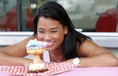Jackie Perez checks out a donut creation at the media preview for the 139th annual Canadian National Exhibition on Wednesday August 16, 2017. (Michael Peake/Toronto Sun)