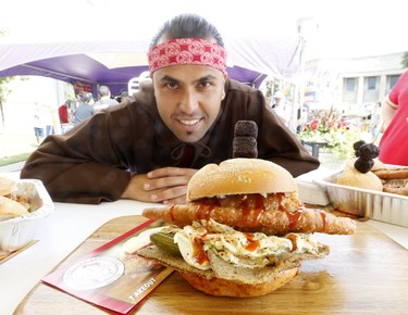 Sean Sarrami of San Francesco foods with the Colossal Coliseum sandwich at the media preview for the 139th annual Canadian National Exhibition on Wednesday August 16, 2017. (Michael Peake/Toronto Sun)