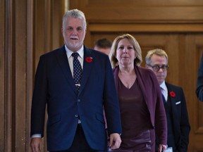 Quebec Premier Philippe Couillard, left, and Christine St-Pierre, Quebec minister of International Relations and La Francophonie walk to a news conference to react to the election of Donald Trump, before heading to a party caucus meeting, Wednesday, November 9, 2016 at the legislature in Quebec City. (THE CANADIAN PRESS/Jacques Boissinot)