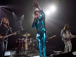 Tragically Hip frontman Gord Downie, centre, leads the band through a concert in Vancouver, Sunday, July 24, 2016.  THE CANADIAN PRESS/Jonathan Hayward