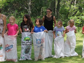 Participants get ready for the potato sack race at Lakeshore Lodge Day at Sandbanks Provincial Park on Wednesday.