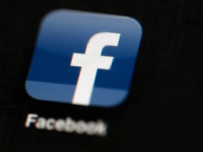 In this May 16, 2012, file photo, the Facebook logo is displayed on an iPad in Philadelphia. Facebook told The Associated Press on Aug. 16, 2017, it has banned the Facebook and Instagram accounts of one of a white nationalist who attended a rally in Charlottesville, Virginia, that ended in deadly violence. (AP Photo/Matt Rourke, File)