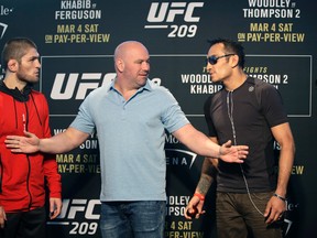 UFC president Dana White stands between fighters Tony Ferguson, right, and Khabib Nurmagomedov during a news conference for UFC 209 on March 2, 2017. (AP Photo/John Locher)