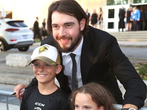 Drew Doughty of the L.A. Kings poses with Matthew, 9, and Jessica, 6, Zambo of London at the All-In for Brain Research fundraiser on Wednesday. (MIKE HENSEN, The London Free Press)