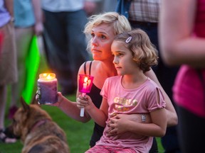 Brigitte Knapp and her daughter Ava Knapp show their support for the victims of Charlottesville. A crowd of people gathered for a Standing in Solidarity with Charlottesville rally in front of St. Catharines City Hall on Wednesday, August 16, 2017. Julie Jocsak/ St. Catharines Standard/ Postmedia Network