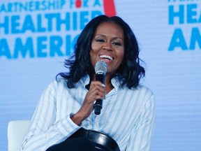 In this Friday, May 12, 2017, file photo, former first lady Michelle Obama smiles while speaking at the Partnership for a Healthier American 2017 Healthier Future Summit in Washington.  (AP Photo/Pablo Martinez Monsivais, File)