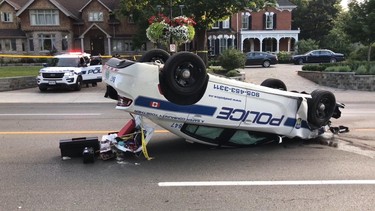 A Peel Regional Police cruiser is seen flipped on its roof after colliding with a van near Main and Queen Sts. Wednesday around 5:30 p.m. (PASCAL MARCHAND/Special to Toronto Sun)