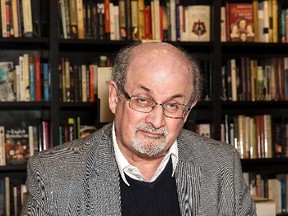 Author Salman Rushdie signs a copy of his new book 'Home' at a book signing in London, Tuesday, June 6, 2017. As Donald Trump continues to face backlash for blaming "both sides" for deadly violence in Charlottesville, Va., celebrated author Rushdie says he's not surprised by the behaviour exhibited by the embattled U.S. president. Grant Pollard/THE CANADIAN PRESS/AP)