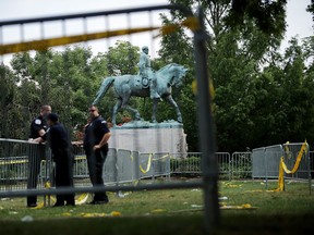 Police stand watch near the statue of Confederate Gen. Robert E. Lee in the center of Emancipation Park the day after the Unite the Right rally devolved into violence August 13, 2017 in Charlottesville, Virginia. (Photo by Chip Somodevilla/Getty Images)