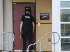 A London police officer waits to be allowed into the Elgin-Middlesex Detention Centre, where an inmate died of a suspected overdose Thursday, Aug. 17, 2017. (DALE CARRUTHERS, The London Free Press)