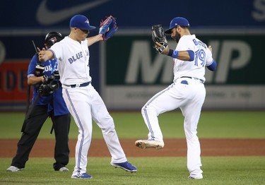 Roberto Osuna #54 of the Toronto Blue Jays celebrates a victory with Jose Bautista #19 during MLB game action against the Tampa Bay Rays at Rogers Centre on August 16, 2017 in Toronto, Canada. (Tom Szczerbowski/Getty Images)
