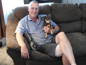 Todd Bertrend is pictured at home with his dog Coco. (Wayne Lowrie/The Recorder and Times)