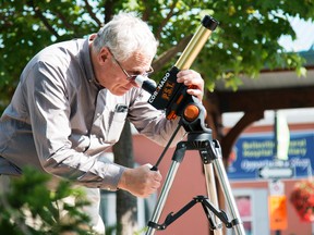 Taylor Bertelink/The Intelligencer
Donald Town looks through a special solar viewing telescope in Market Square behind Belleville city hall. He has only ever seen one total solar eclipse in his lifetime and describes the experience as, “amazing.”