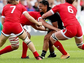 Canadian defenders stop a New Zealand ballcarrier during 2017 Women's Rugby World Cup action Thursday in Dublin. (James Crombie photo)