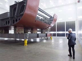 Kevin McCoy, president of Irving Shipbuilding, leads a tour as workers construct components of the Arctic offshore patrol ships at their facility in Halifax on Friday, March 4, 2016. THE CANADIAN PRESS/Andrew Vaughan
