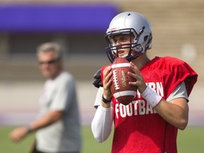 Western quarterback prospect Chris Merchant listens to coach Jamie Bone as head coach Greg Marshall watches from a distance at practice in London, Ont. on Tuesday August 16, 2016. (Mike Hensen/The London Free Press/Postmedia Network)