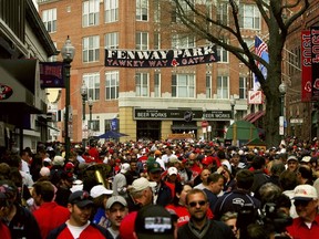 Fans walk along Yawkey Way outside of Fenway Park before the Boston Red Sox take on the Toronto Blue Jays before the Red Sox home opener on April 11, 2006 at Fenway Park in Boston, Massachusetts. (Travis Lindquist/Getty Images)