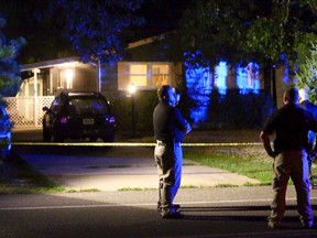 Ocean County Sheriff's Department officers investigate the scene of a homicide in Lacey Township, N.J. on Wednesday, Aug. 16, 2017. A man is believed to have killed his wife, their 7-year-old son and the family dog in their home before killing himself, authorities said Thursday, Aug. 17. The Ocean County prosecutor's office said a 48-year-old woman, the child and the dog were found dead Wednesday afternoon in their Lacey Township home. A 51-year-old man died at a hospital of self-inflicted wounds, prosecutors said. (Thomas P. Costello/The Asbury Park Press via AP)