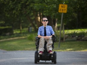 There are no sidewalks in Jeff Preston's neighbourhood in London. A parked car on a street forces him into the dangerous position of having to drive his wheelchair around it and into the middle of the road. During winter months, he is unable to travel in his chair at all. Derek Ruttan/The London Free Press/Postmedia Network