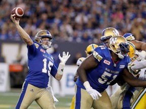 Winnipeg Blue Bombers quarterback Matt Nichols (15) fires a pass while playing against the Edmonton Eskimos during the first half of CFL football action in Winnipeg, Thursday, August 17, 2017.