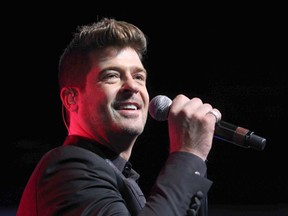 In this Aug. 7, 2015, file photo, Robin Thicke performs during the Steve Harvey Morning Show live broadcast at the Georgia World Congress Center in Atlanta. Thicke's girlfriend, April Love Geary, announced on Instagram Aug. 17, 2017, that she’s expecting a baby with the singer. (Photo by Robb D. Cohen/Invision/AP, File)
