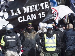 Police hold back far-right protesters during a demonstration in Montreal on March 4, 2017. A Montreal anti-fascist group said in a statement that it's calling on anti-fascist and anti-racist groups to head to Quebec's capital to oppose a demonstration by La Meute this weekend. (Graham Hughes/The Canadian Press/Files)