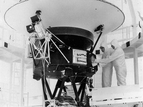 In this Aug. 4, 1977 photo provided by NASA, the "Sounds of Earth" record is mounted on the Voyager 2 spacecraft in the Safe-1 Building at the Kennedy Space Center, Fla., prior to encapsulation in the protective shroud. Sunday, Aug. 20, 2017 marks the 40th anniversary of NASA's launch of Voyager 2, now almost 11 billion miles distant. (AP Photo/NASA)