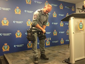 Sgt. Shane Cooke of the Tactical Support Team demonstrates how to use a tourniquet on his upper leg at a press conference Friday morning, Aug. 18, 2017. Jason Friesen/Winnipeg Sun
