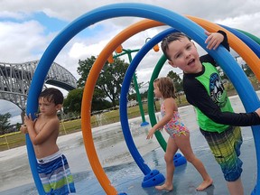 Bentley Ellis, 5 (left), and Lorelei Metcalf, 5, and Ryker Stewart, 4, on Friday were squeezing out as much of the of what’s left of the summer heat as they can played at the newly-opened waterfront park splash pad in Point Edward. (Jeremiah Rodriguez/The Observer)