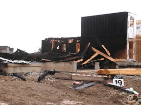 Two homes under construction, and the entire facing wall of a third home were heavily damaged by a suspicious fire overnight on Lawson Avenue, west of Sandbar Street in London, Ont. (MIKE HENSEN, The London Free Press)