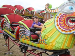 Emma Verteramo, 8, rides the mini roller coaster at the Iron Horse Festival on Friday afternoon. She was one of many people enjoying the rides yesterday as the weather cleared up just enough for people to make it out to the rail lands to enjoy the midway and other events of the festival. (LAURA BROADLEY, Times-Journal)