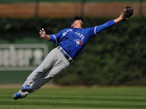 Toronto Blue Jays second baseman Darwin Barney misses an RBI single hit by Chicago Cubs' Albert Almora Jr. during an MLB game on Aug. 18, 2017. (AP Photo/Paul Beaty)