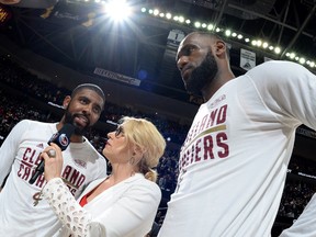 Doris Burke interviews Kyrie Irving #2 and LeBron James #23 of the Cleveland Cavaliers after Game Four of the 2017 NBA Finals on June 9, 2017 at Quicken Loans Arena in Cleveland, Ohio. (Andrew D. Bernstein/NBAE via Getty Images)