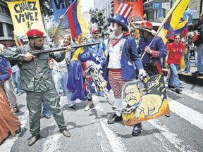 Government supporters perform a parody involving a Venezuelan militia up against Uncle Sam, a personification of the U.S government, during an anti-imperialist march in Caracas Monday to denounce U.S. President Donald Trump?s talk of a ?military option? for resolving the country?s political crisis. (Ariana Cubillos/Associated Press)