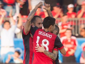 Toronto FC midfielder Victor Vazquez, left, celebrates with Marco Delgado and Sebastian Giovinco after scoring against the Portland Timbers during MLS action in Toronto on Aug. 12, 2017. (THE CANADIAN PRESS/Chris Young)