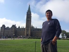 Clarence Neshinapaise stands on Parliament Hill after completing his 1,800-kilometre walk on Friday.