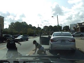 In this Saturday, Aug. 12, 2017 image taken from video provided by the Euclid Police Dept., Euclid police officer Michael Amiott punches Richard Hubbard on a street in Euclid, Ohio. (Euclid Police Dept. via AP)