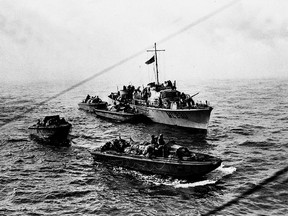 Personnel landing craft draw away from a motor torpedo boat to start their run-in to the beaches during the raid on Dieppe, France, on Aug. 19, 1942. (The Canadian Press/National Archives of Canada, PA-113247)