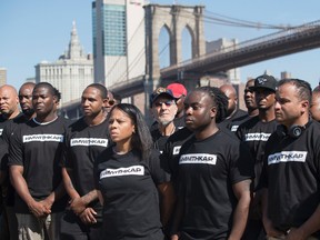 Retired New York City Police Officer Frank Serpico, center, stands with other members of law enforcement during a rally to show support for Colin Kaepernick, Saturday, Aug. 19, 2017, in New York. (AP Photo/Mary Altaffer)